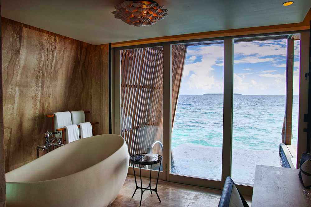 luxury resort bathroom with view of sea